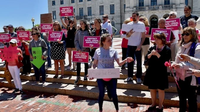 Nearly 100 people hold noon time, pro-choice protest at Rhode Island State House