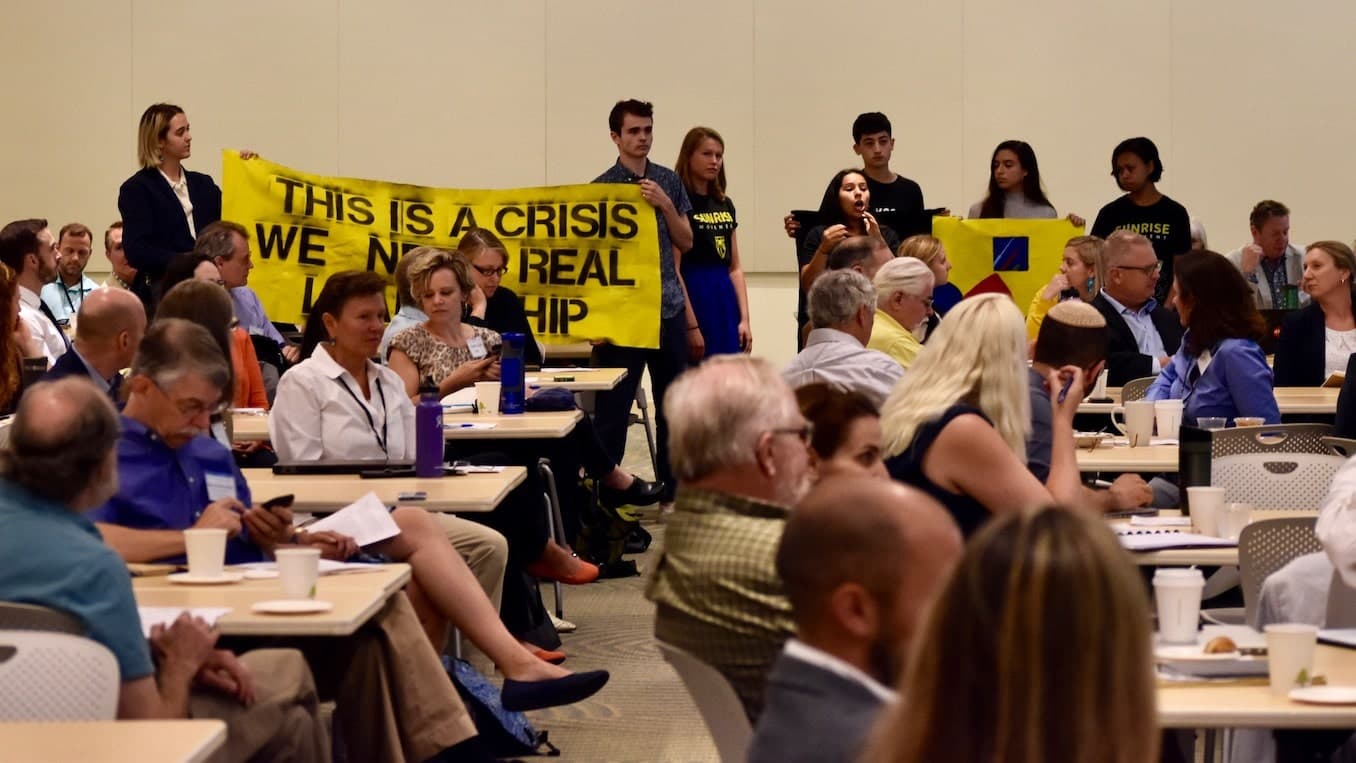 Sunrise RI confronts Senator Whitehouse at Environmental Business Council event
