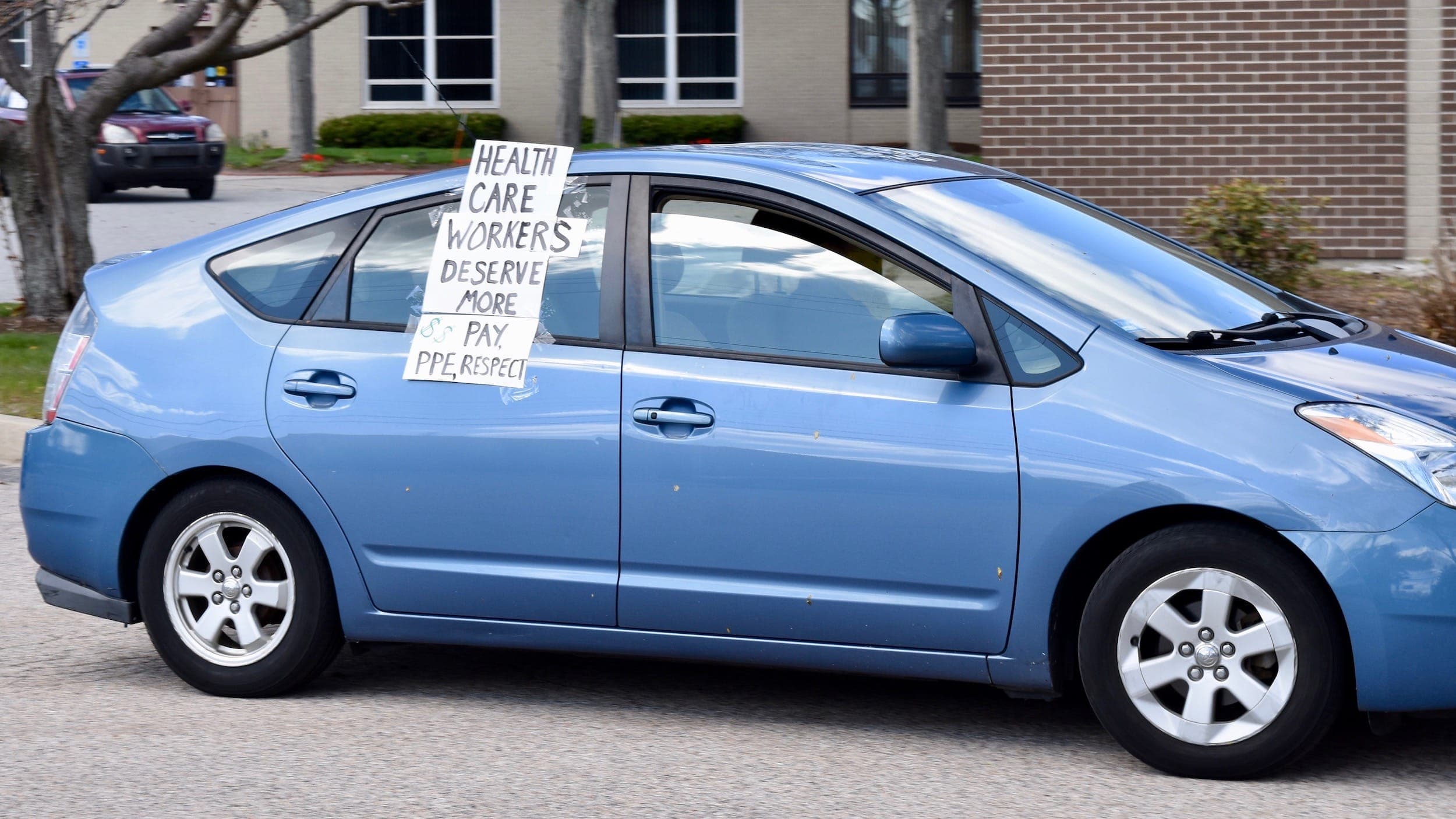 Frontline workers hold "emergency caravan" for hazard pay, PPE and safe staffing