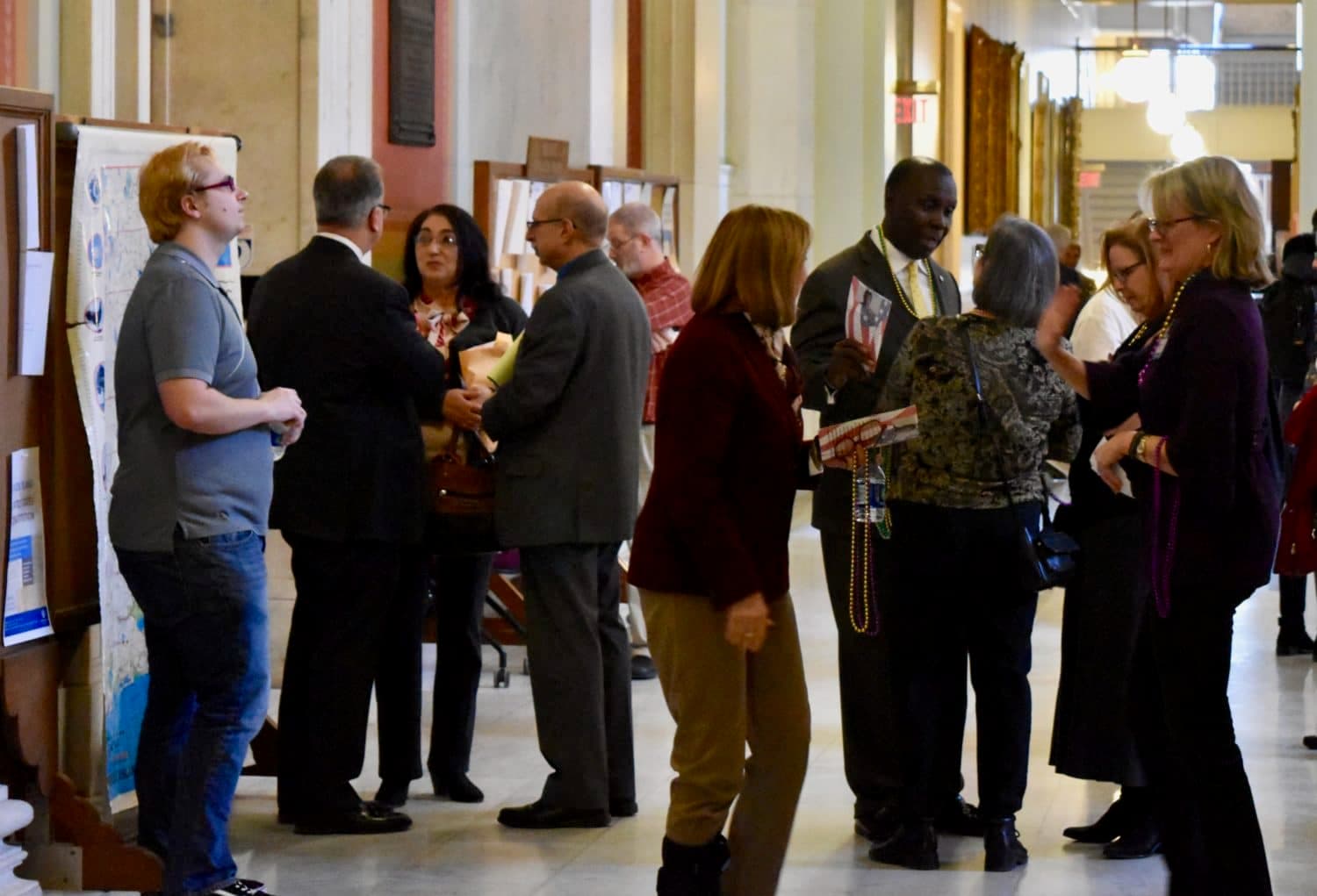 Reproductive healthcare activists give Mardi Gras beads to legislators