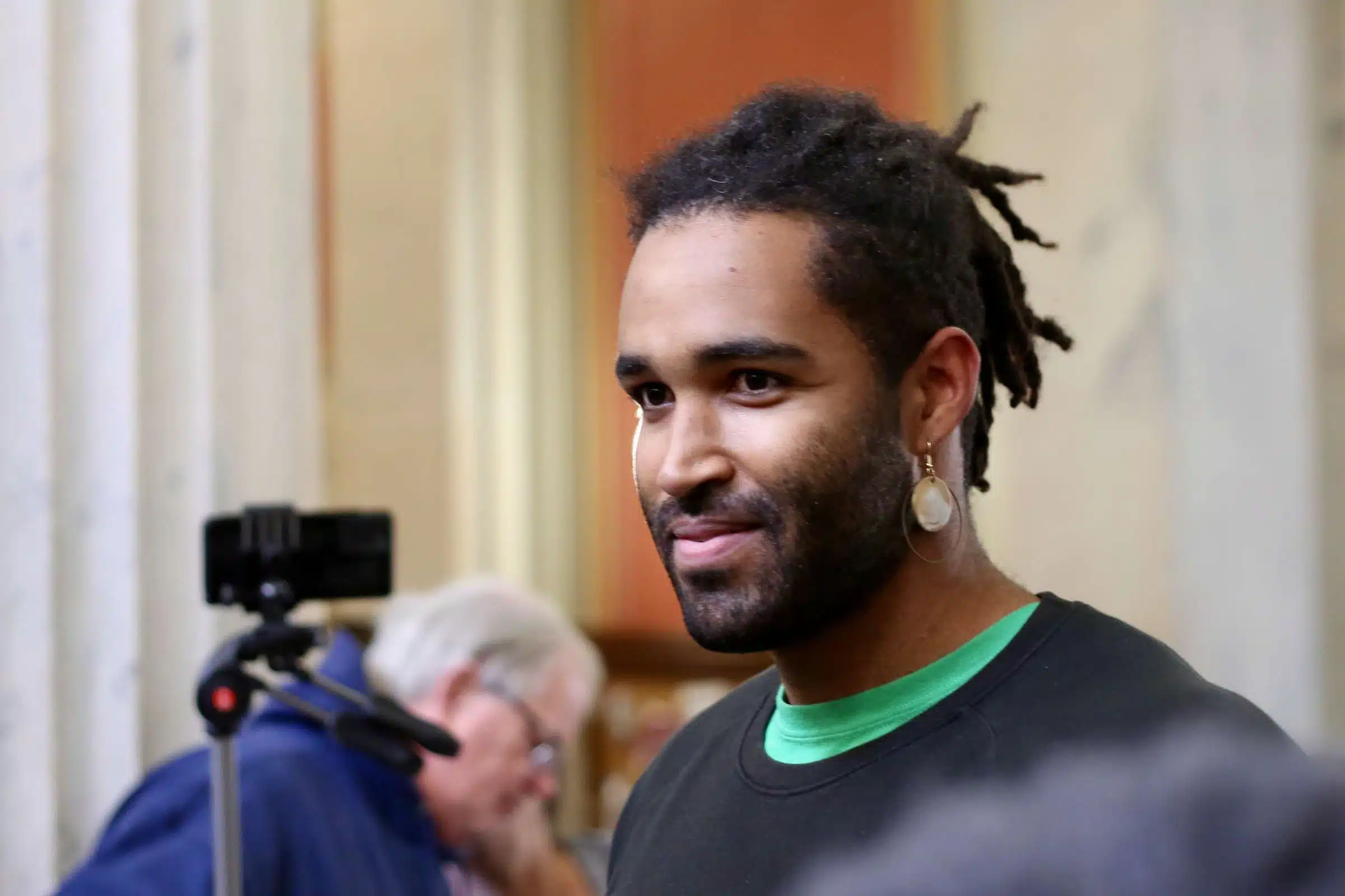 Jordan, a protester at a rally against Rhode Island Governor Daniel McKee, opposing his plan to evict a homeless encampment