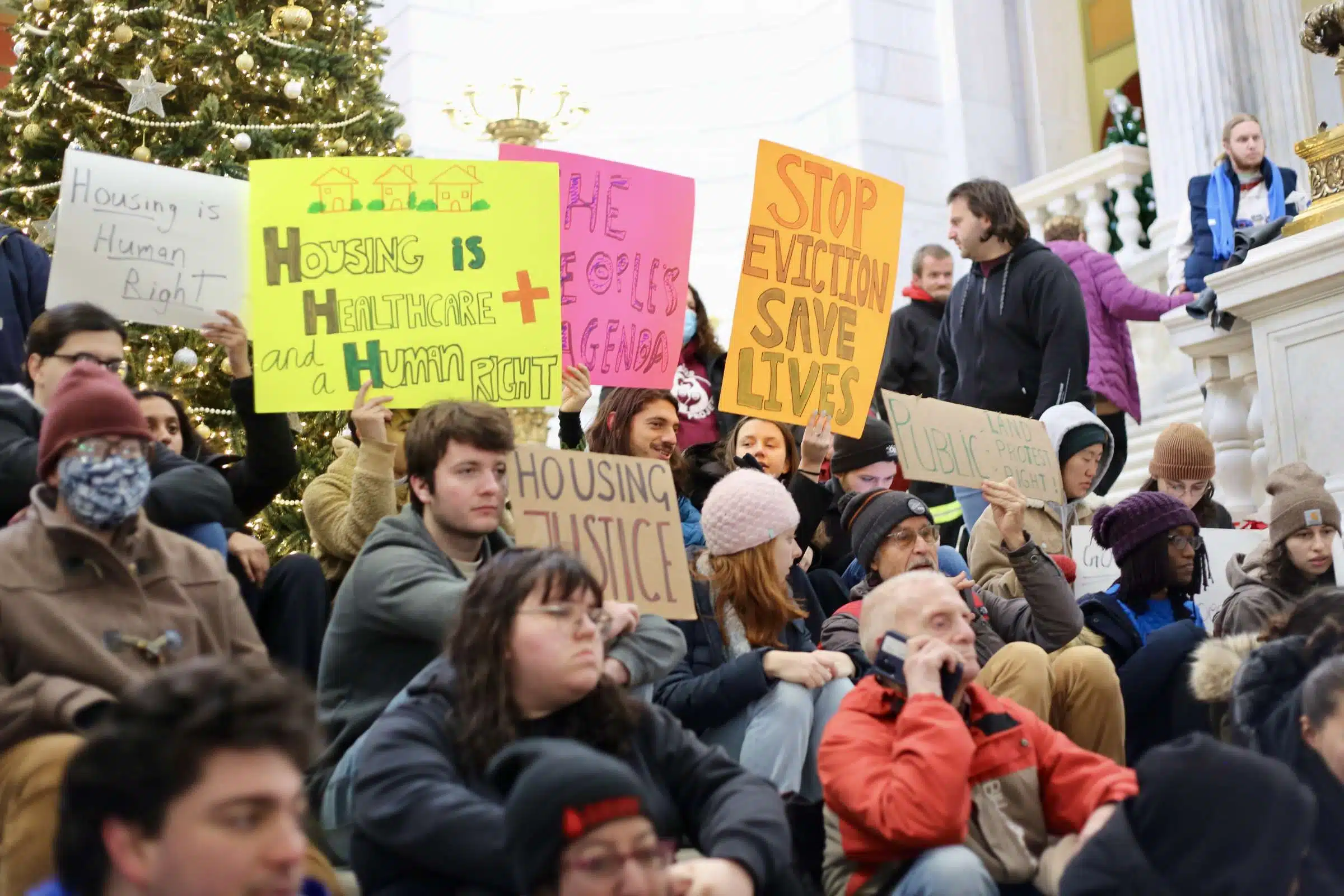 Protesters at a rally against Rhode Island Governor Daniel McKee, opposing his plan to evict a homeless encampment