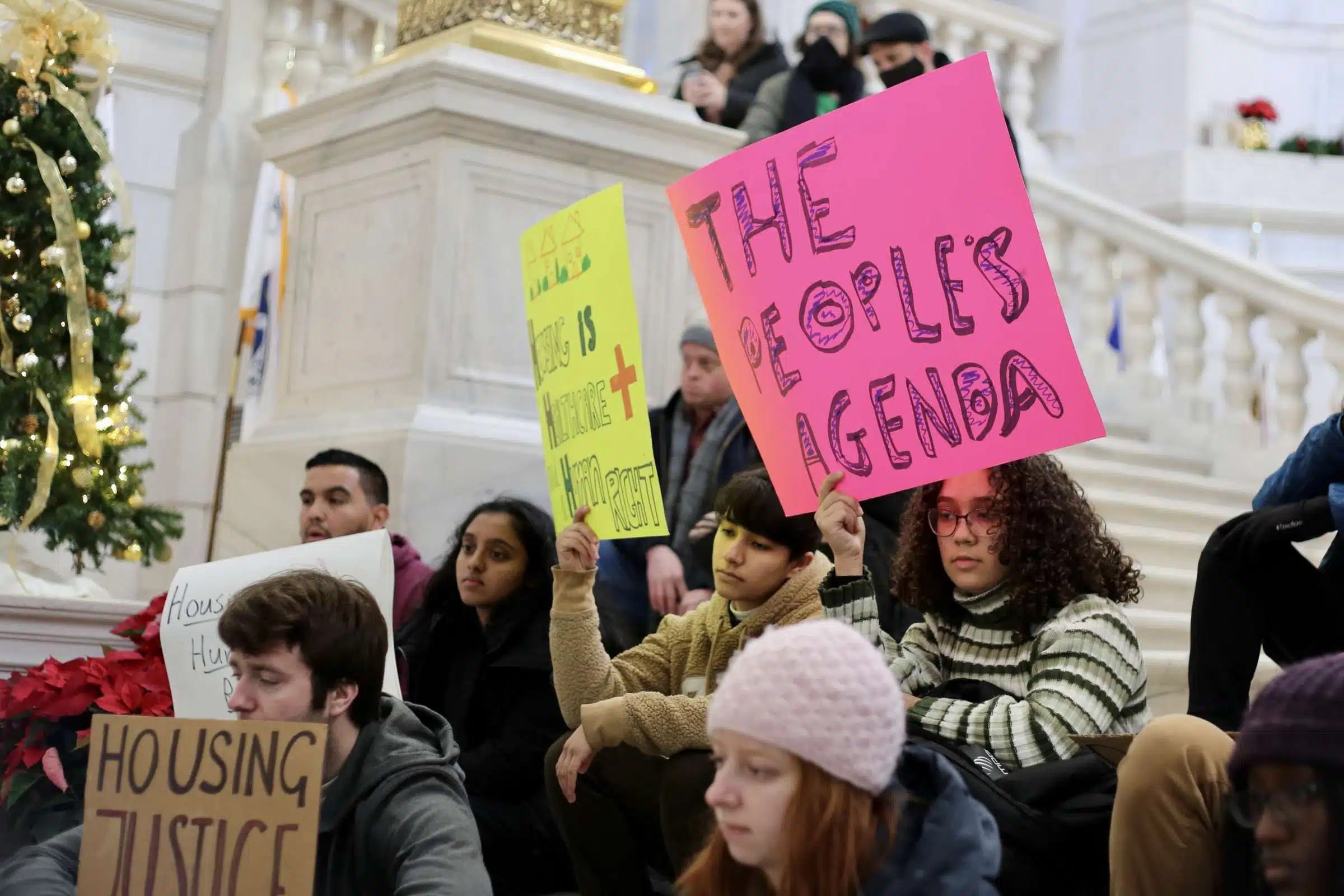Protesters at a rally against Rhode Island Governor Daniel McKee, opposing his plan to evict a homeless encampment