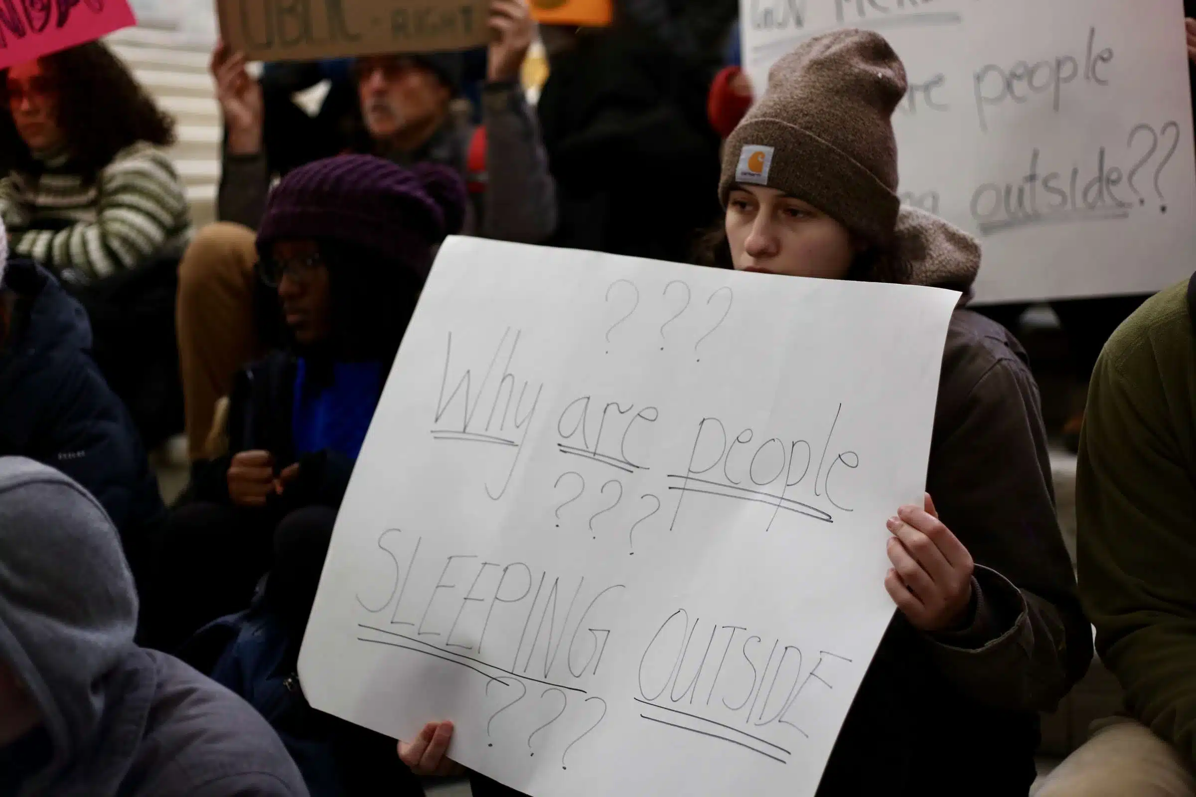 Protester at a rally against Rhode Island Governor Daniel McKee, opposing his plan to evict a homeless encampment