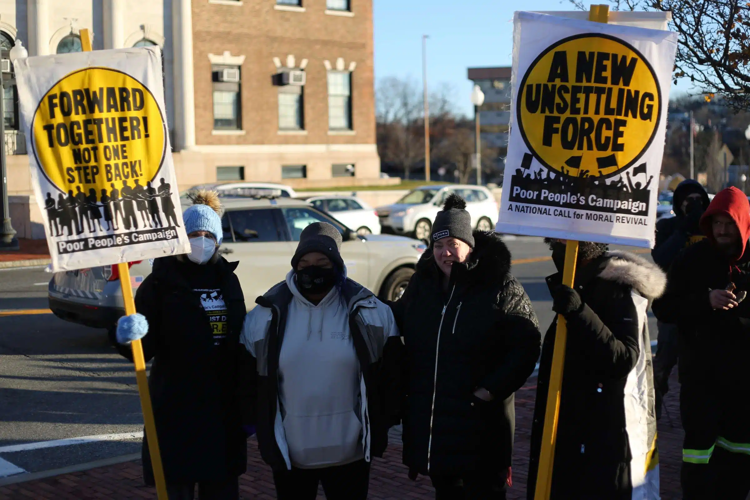 Activists from the Rhode Island Poor People's Campaign outside the Rhode Island State House on a cold December morning protesting Governor Daniel McKee's homeless encampment eviction order.