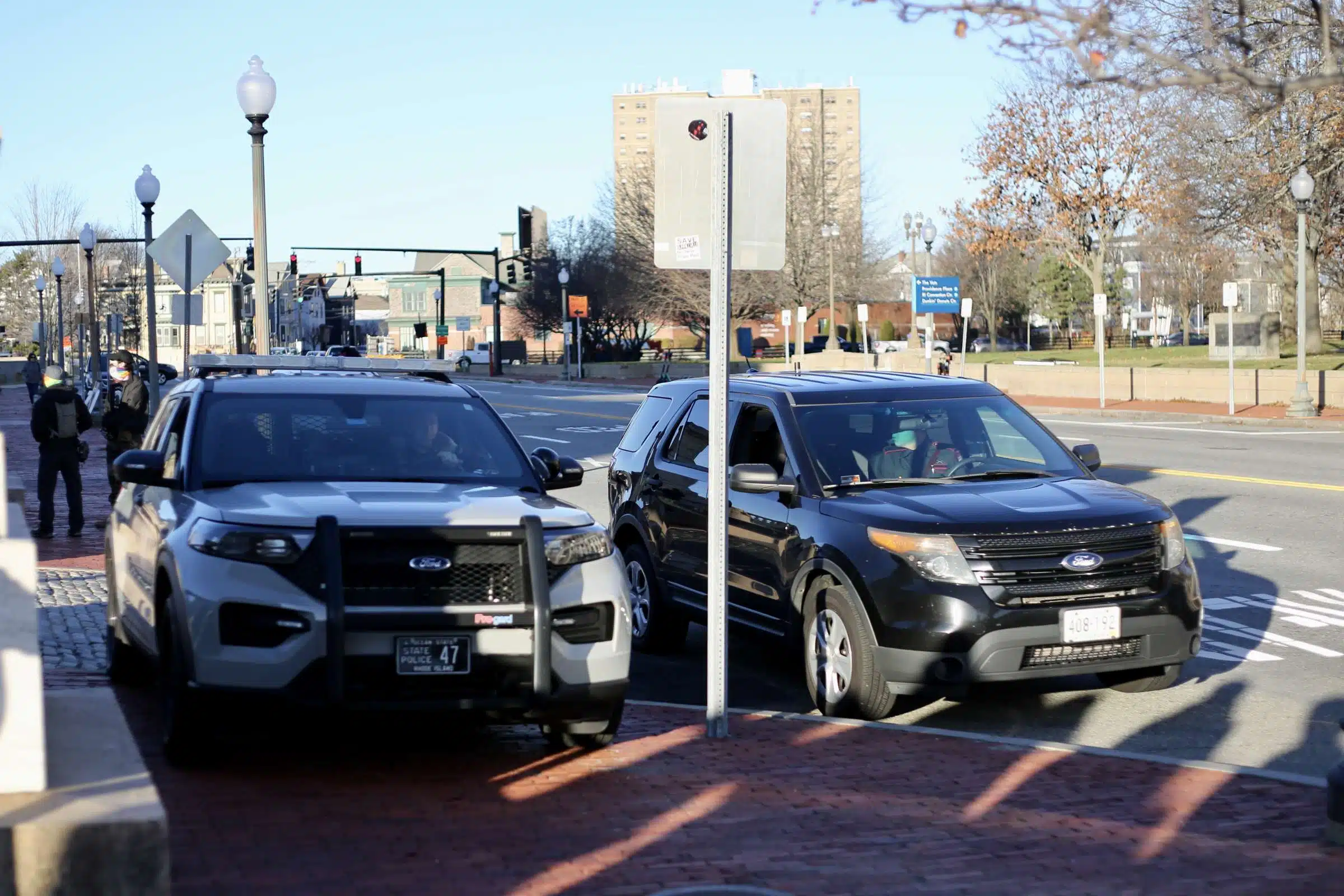 Rhode Island State Police parked near a rally against Rhode Island Governor Daniel McKee, opposing his plan to evict a homeless encampment