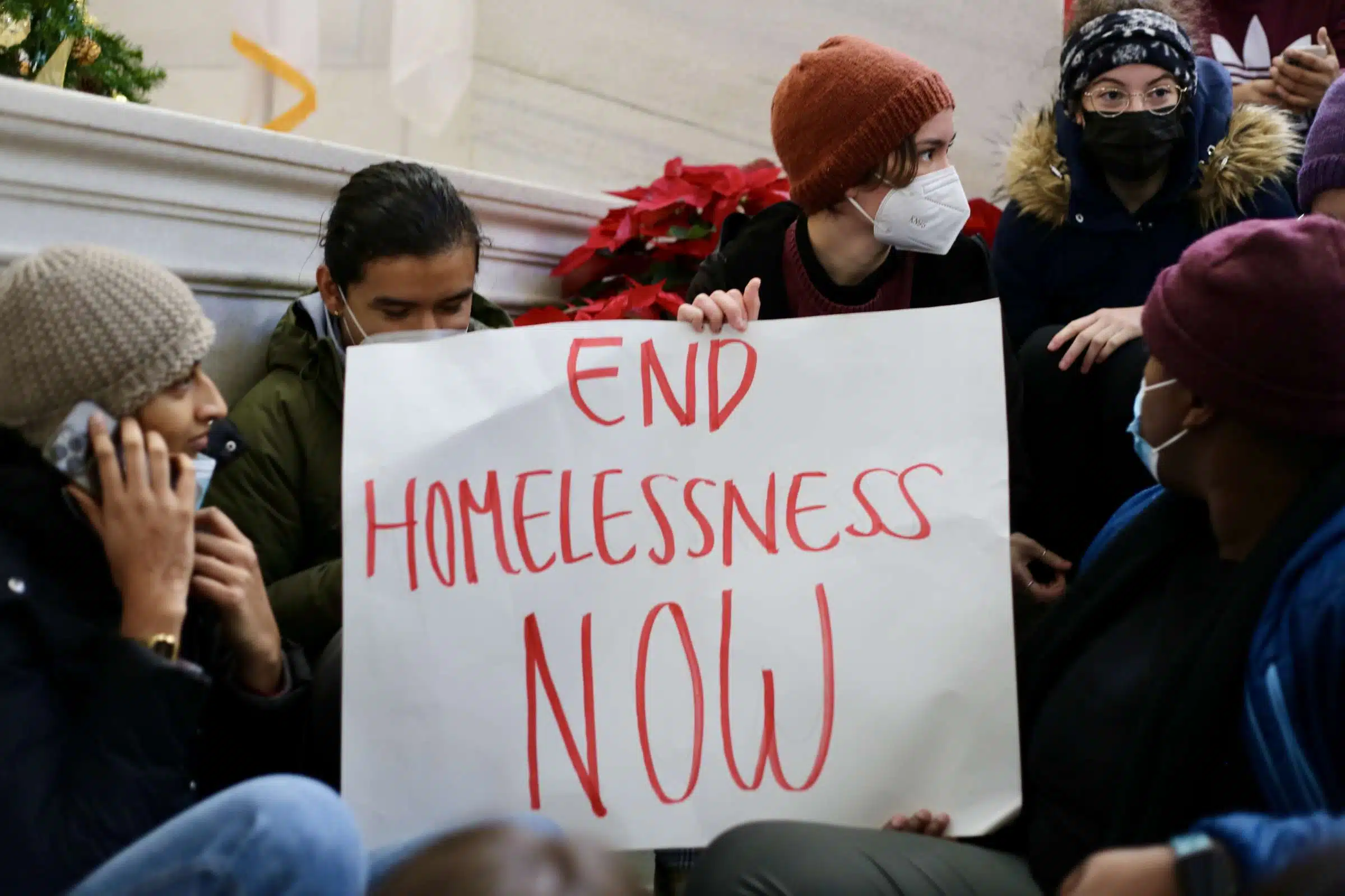 Protesters at a rally against Rhode Island Governor Daniel McKee, opposing his plan to evict a homeless encampment